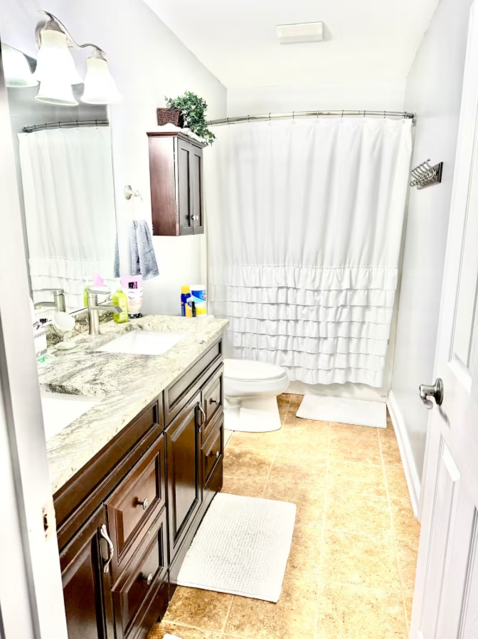 Full bathroom with vanity and shower